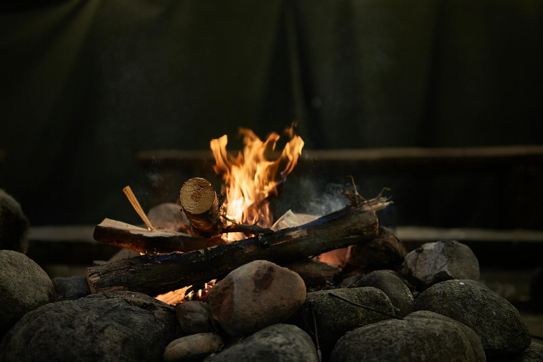 burning wood above rocks